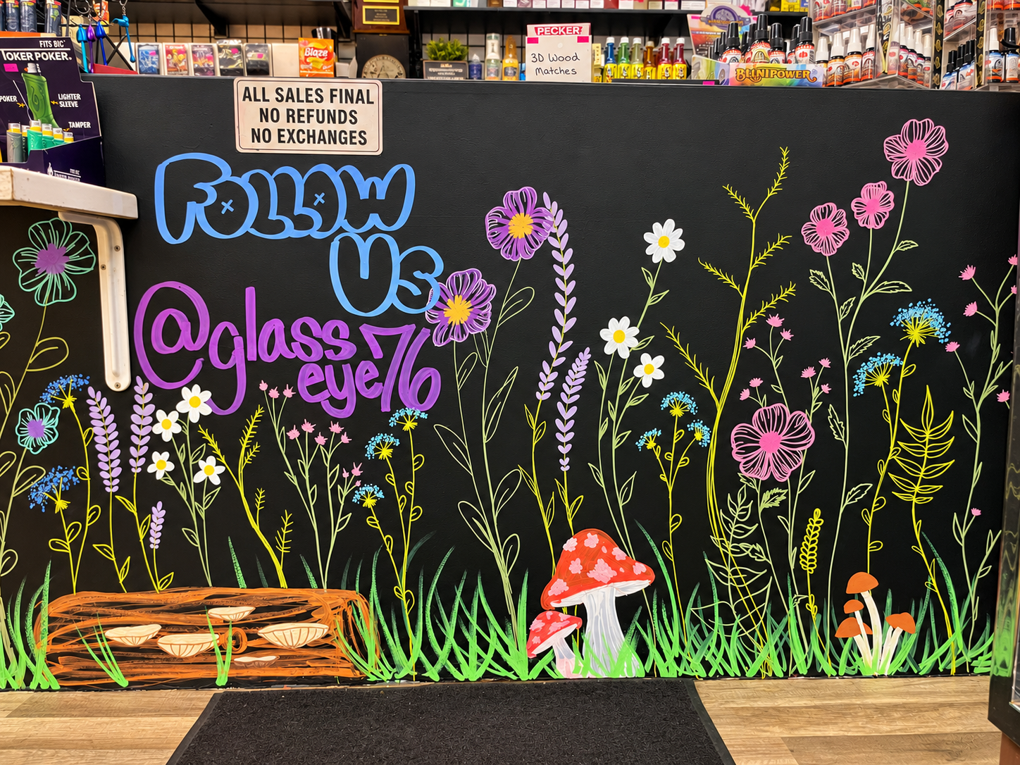 Hand-drawn flowers and mushrooms decorating the shop wall