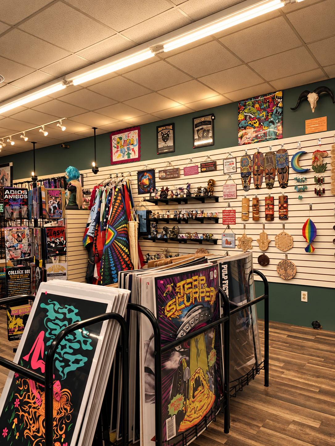 Upright view of the shop interior, colorful wall art, and print racks