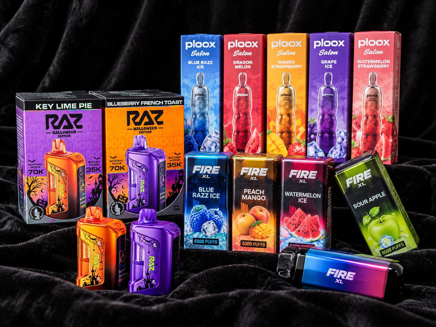 Colorful vape products arranged on dark fabric